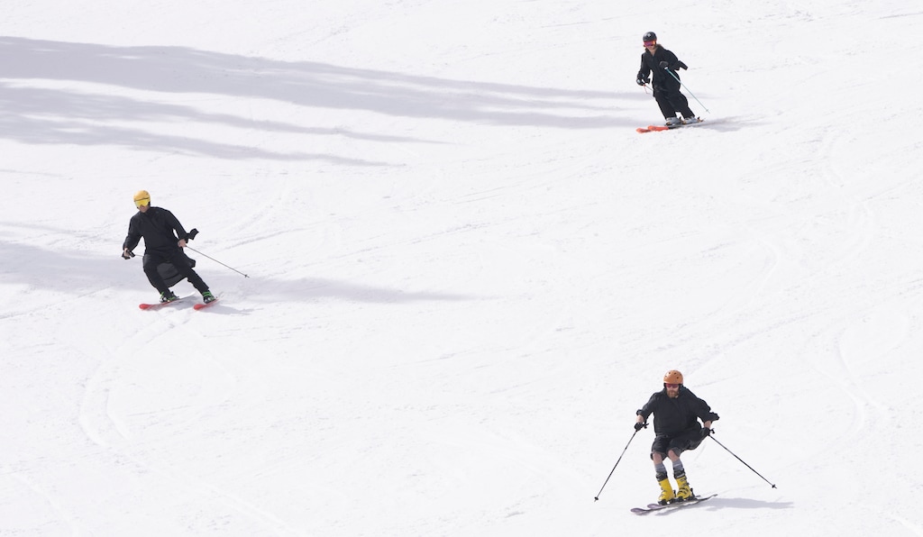 (Rick Egan | The Salt Lake Tribune)  Michael Shaw, Michelle Shuman, and Joseph Frank wear their graduation gowns as they ski at Solitude, on Wednesday, May 3, 2023. The three friends were graduating from the University of Utah MBA program the next day.
