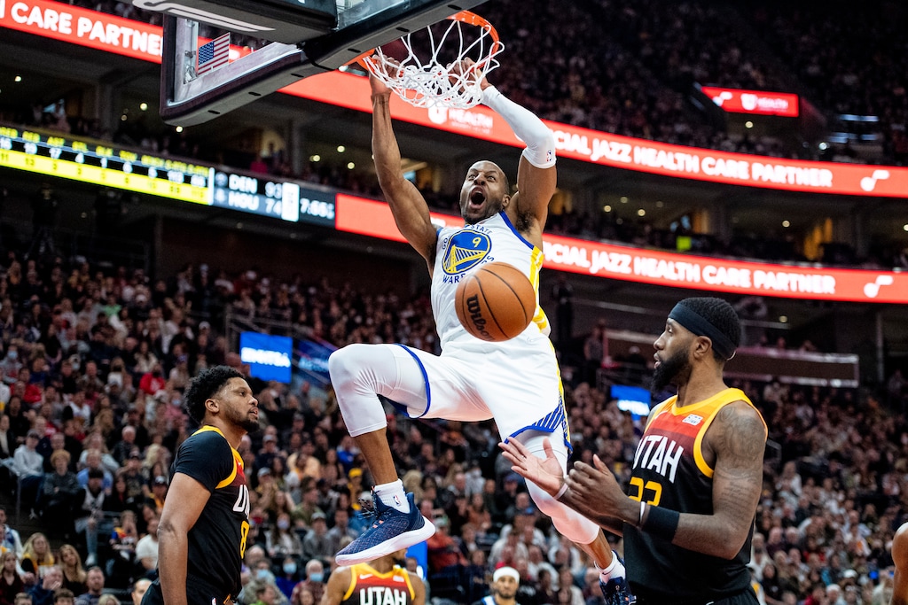 (Isaac Hale | The Associated Press) Golden State Warriors forward Andre Iguodala (9) gets by the defense of Royce O'Neale, right, and Rudy Gay for a dunk in the first half during an NBA basketball game against the Utah Jazz on Saturday, Jan. 1, 2022, in Salt Lake City.