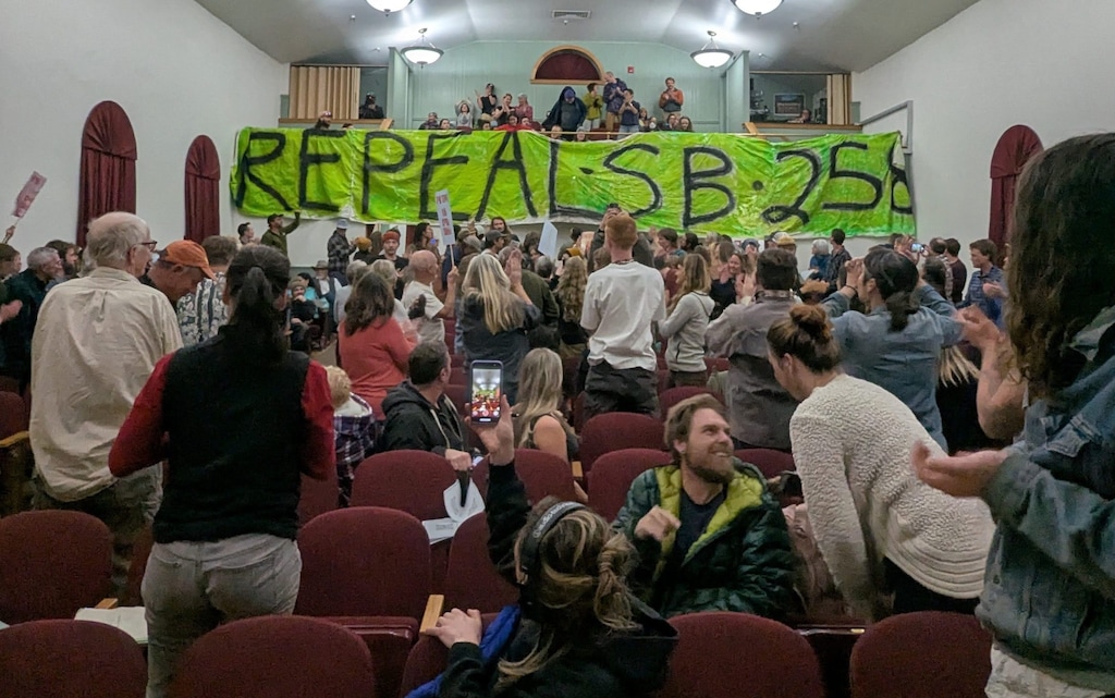 (Andrew Christiansen | The Times-Independent) A banner reading “Repeal SB258” is unfurled from the balcony during the public hearing at Star Hall on March 5, 2025. SB258 is a law that allows landowners in unincorporated areas to pursue the creation of a preliminary municipality, a process which has drawn significant local opposition.