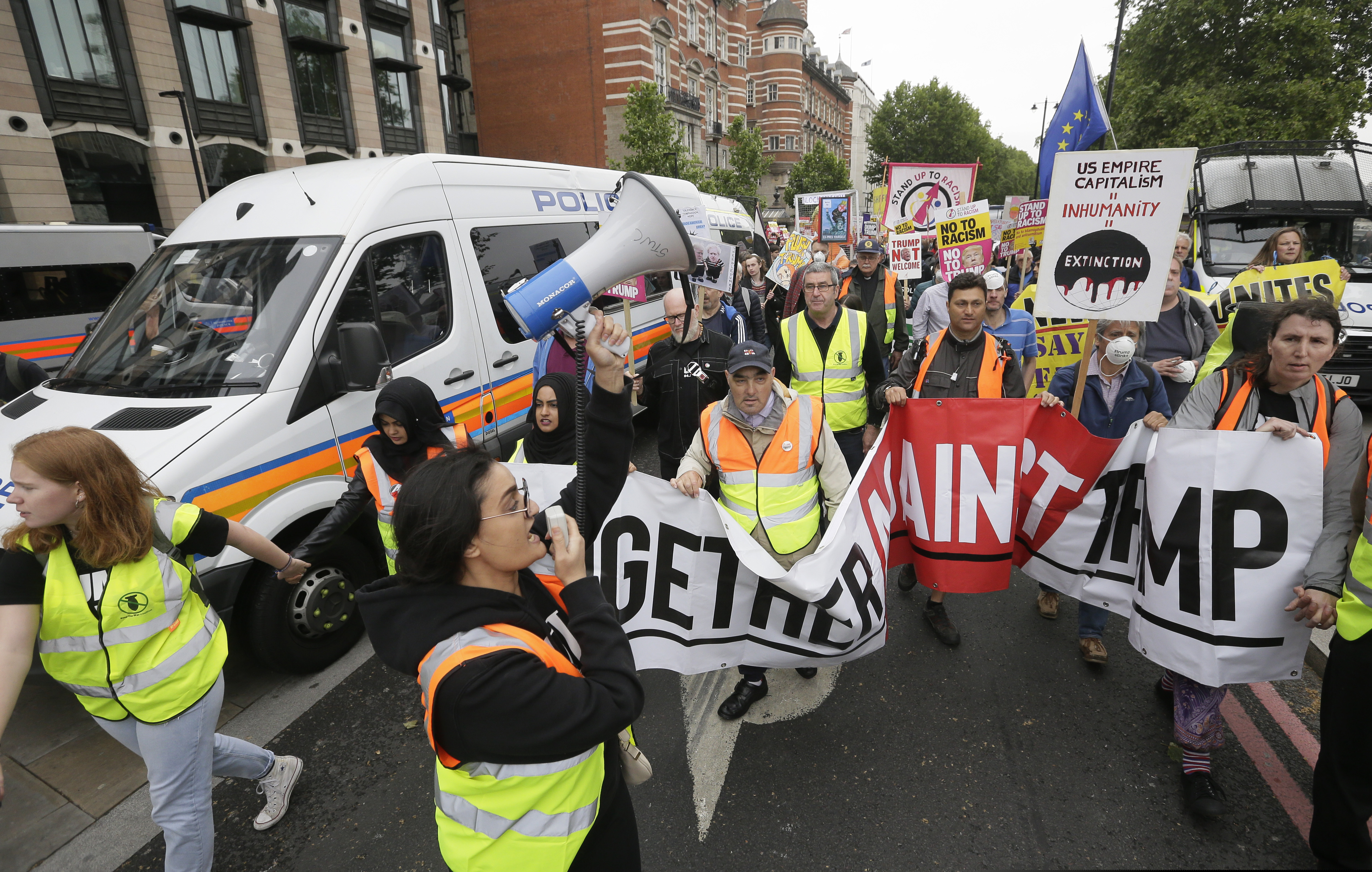 People carry signs and banners as they march through central London to demonstrate against the state visit of President Donald Trump, Tuesday, June 4, 2019. Trump will turn from pageantry to policy Tuesday as he joins British Prime Minister Theresa May for a day of talks likely to highlight fresh uncertainty in the allies' storied relationship. (AP Photo/Tim Ireland)