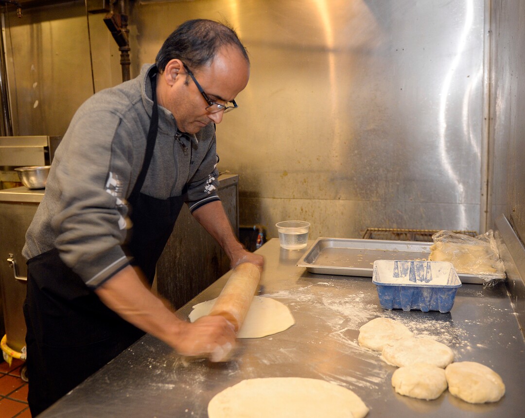 (Al Hartmann  |  The Salt Lake Tribune) 	
Kamal Niroula prepares naan, a traditional flatbread, for recently opened Bhutan House in Sandy. Kamal and his wife, Geeta, moved to Utah with their three children in 2010. Originally from Bhutan, they lived in Nepal before their resettlement in the United States.  The couple participated in the Spice Kitchen Incubator program, initially catering and doing special events before opening their own restaurant, which serves foods from Bhutan, Nepal and India.