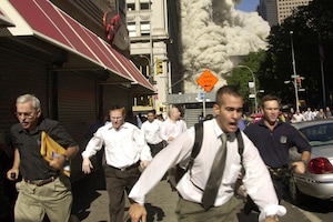 (Suzanne Plunkett | AP) People run from a collapsing World Trade Center tower in New York, Sept. 11, 2001. This photo ran on the front page of The Salt Lake Tribune on Sept. 12, 2001, the day after the 9/11 attacks.