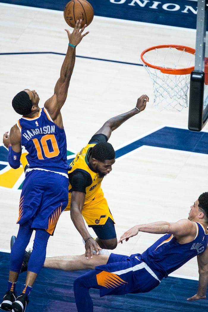 (Chris Detrick  |  The Salt Lake Tribune)  Phoenix Suns guard Shaquille Harrison (10) gets the rebound as Utah Jazz forward Royce O'Neale (23) fouls Phoenix Suns guard Devin Booker (1) during the game at Vivint Smart Home Arena Thursday, March 15, 2018. 