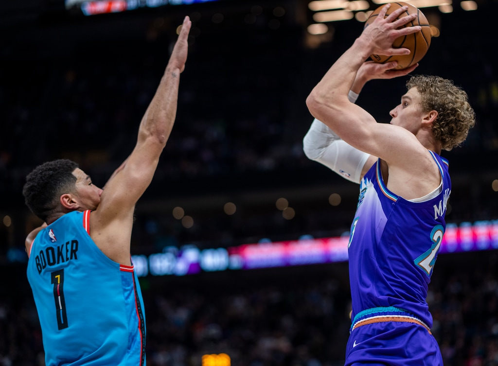(Rick Egan | The Salt Lake Tribune) Utah Jazz forward Lauri Markkanen (23) hits a shot with seconds on the shot clock as Phoenix Suns guard Devin Booker (1), in NBA action between the Utah Jazz and the Phoenix Suns, at Vivint Arena, on Friday, Nov. 18, 2022.