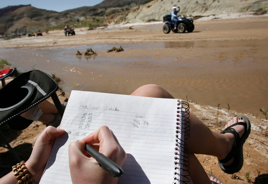 (Scott Sommerdorf  |  Tribune File Photo)  McKenzie Carlsle tallies the number of vehicles that pass the "Picnic With a Purpose" which took up a spot alongside the Paria Riverbed to protest the ATV'ers protest on May 9, 2009. When the picnickers left their spot, they had tallied 115 vehicles.