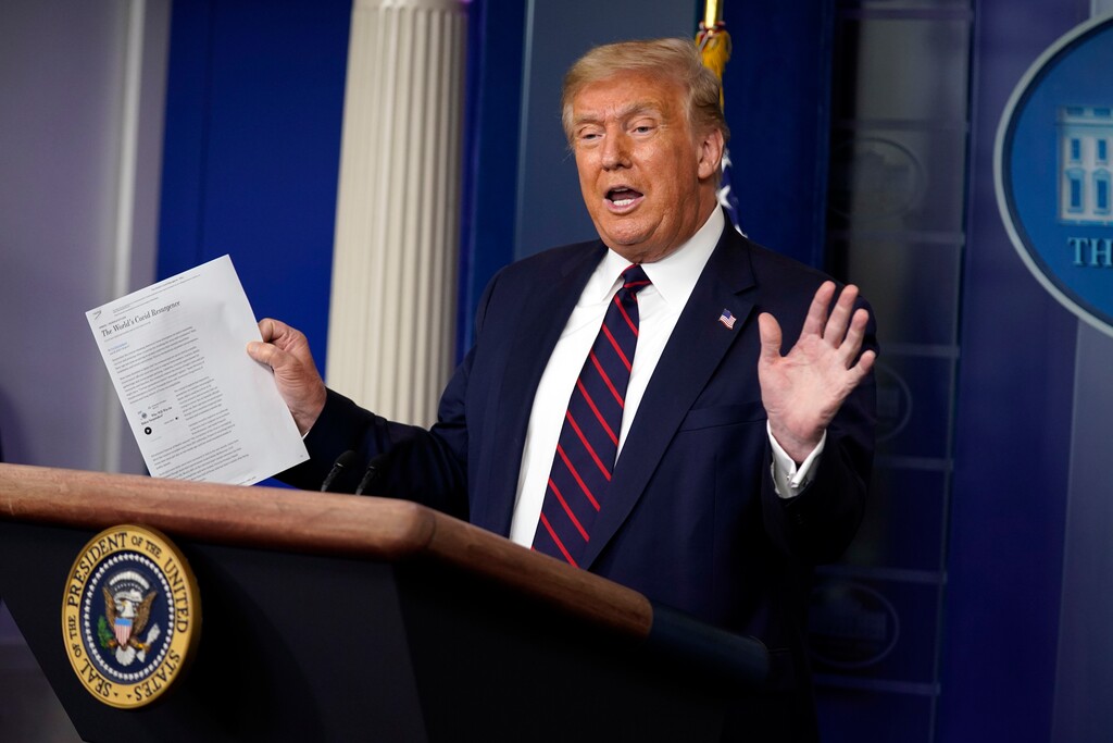 (Evan Vucci | AP file photo) President Donald Trump holds an article as he speaks during a news conference at the White House, Thursday, July 30, 2020, in Washington.