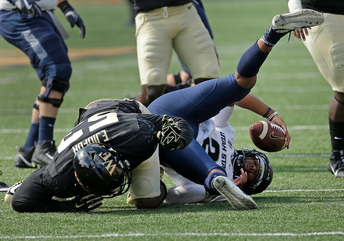Utah State's Kent Myers (2) is sacked by Wake Forest's Duke Ejiofor (53) in the first half of an NCAA college football game in Winston-Salem, N.C., Saturday, Sept. 16, 2017. (AP Photo/Chuck Burton)