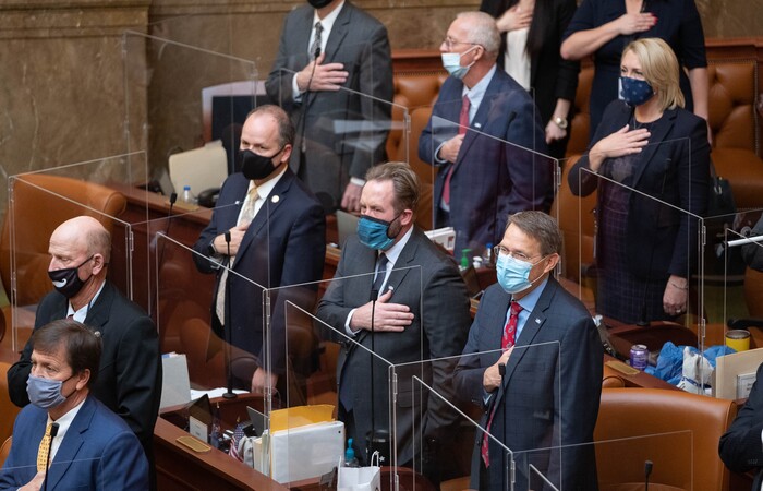 (Francisco Kjolseth  | The Salt Lake Tribune) Members of the House of Representatives recite the pledge of allegiance partitioned by plexiglass as the Utah State Legislature opens the 2021 legislative session at the Capitol in Salt Lake City on Tuesday, Jan. 19, 2021.