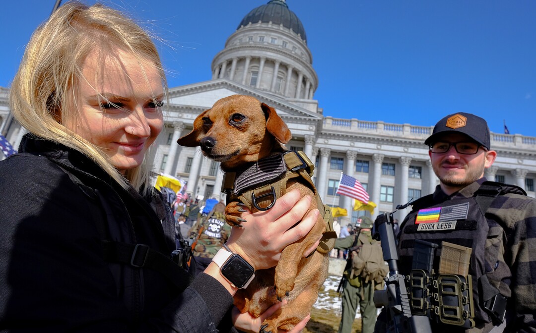 (Francisco Kjolseth  |  The Salt Lake Tribune) Alli Greathouse holds her dog Chico as she and her boyfriend Keaton Overton join hundreds of pro gun proponents gathered at the Utah Capitol in Salt Lake City on Saturday, Feb. 8, 2020, in response to recent proposals from legislators, including red-flag laws, universal background checks and the elimination of private transfers.