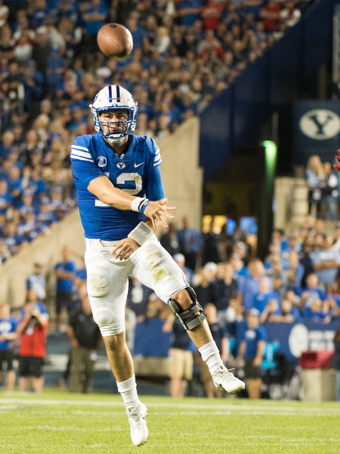 (Rick Egan  |  The Salt Lake Tribune)   Brigham Young Cougars quarterback Tanner Mangum (12) throws a pass, in football action BYU vs Utah, at Lavell Edwards Stadium in Provo, Saturday, September 9, 2017.