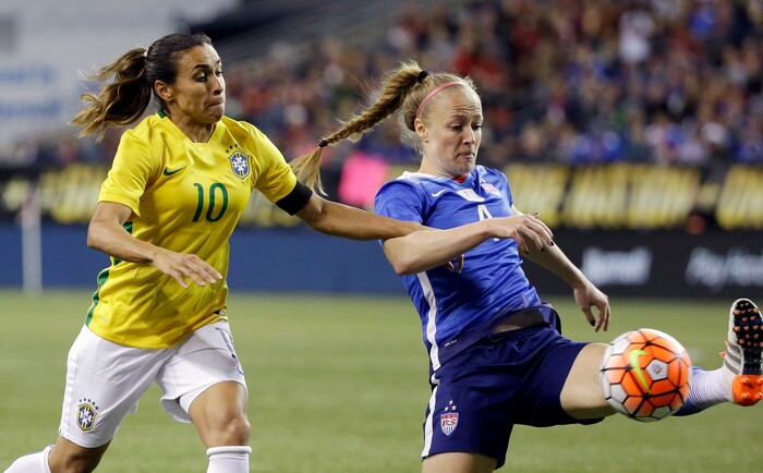 Brazil's Marta (10) and United States' Becky Sauerbrunn vie for the ball during the second half of an international friendly soccer match Wednesday, Oct. 21, 2015, in Seattle. The game ended in a 1-1 draw. (AP Photo/Elaine Thompson)