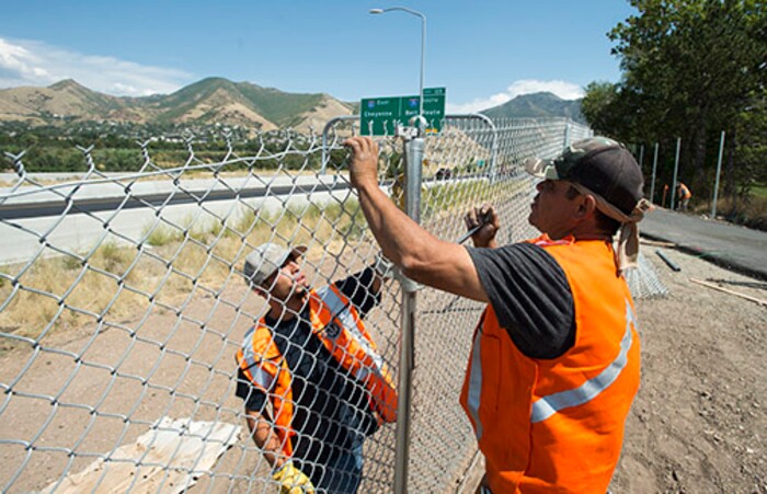 (Rick Egan | The Salt Lake Tribune) Alejandro Ocha and Ronie Ocha work on a chain-link fence along a new segment of Parley's Trail on Wednesday, Aug. 30, 2017.