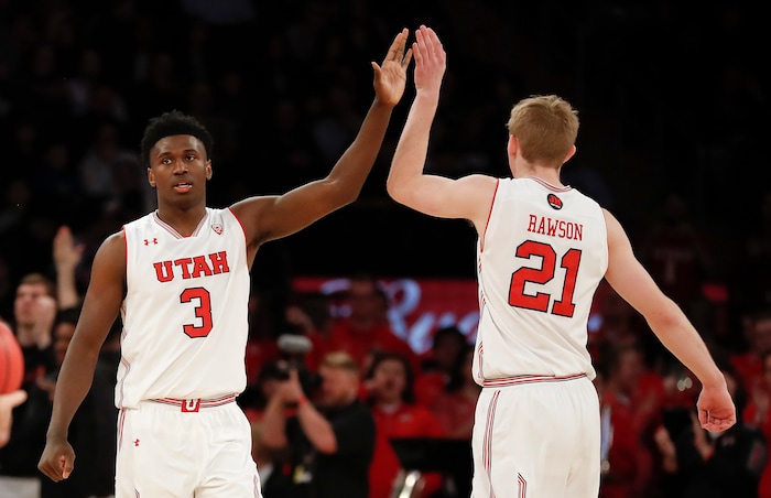 Utah forwards Donnie Tillman (3) and Tyler Rawson (21) high-five as Western Kentucky calls a timeout late in the fourth quarter of an NCAA college basketball game in the semifinals of the NIT, Tuesday, March 27, 2018, in New York. Utah won 69-64. (AP Photo/Julie Jacobson)