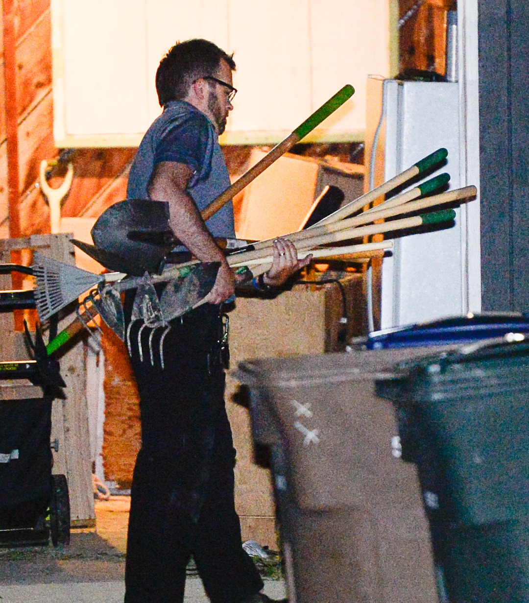 (Francisco Kjolseth  |  The Salt Lake Tribune)  Police investigators carry in multiple rakes and shovels into the backyard of a home at 547 N. 1000 West in Salt Lake City as part of the disappearance of University of Utah student MacKenzie Lueck on Wed. June 26, 2019.
