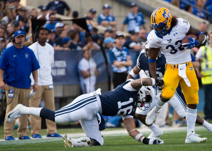 (Rick Egan  |  The Salt Lake Tribune)    Brigham Young Cougars linebacker Sione Takitaki (16) gets his hands on McNeese State Cowboys running back David Hamm (32), in football action Brigham Young Cougars vs McNeese State Cowboys at Lavell Edwards Stadium, Saturday, Sept. 22, 2018.



