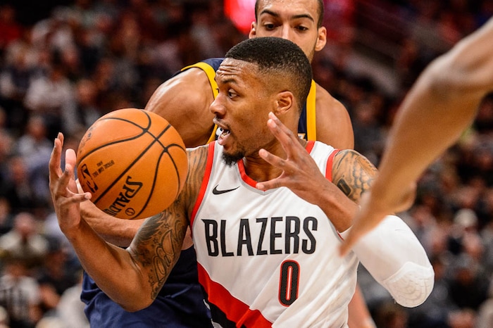 (Trent Nelson | The Salt Lake Tribune)  Portland Trail Blazers guard Damian Lillard (0) drives past Utah Jazz center Rudy Gobert (27) as the Utah Jazz host the Portland Trail Blazers, NBA basketball in Salt Lake City, Wednesday November 1, 2017.