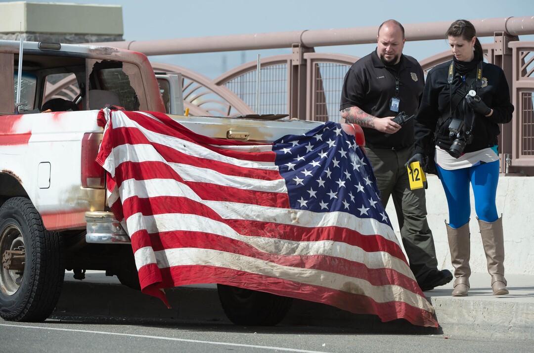 (Francisco Kjolseth  | The Salt Lake Tribune) Investigators collect evidence from a vehicle as numerous police agencies respond to a man driving erratically and claiming to have a gun and a bomb with an initial police chase ending on Center Street over Legacy Highway on Wednesday, March 17, 2021. The suspect was taken into custody.