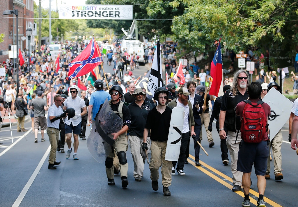 (AP Photo | Steve Helber) White nationalist demonstrators walk through town after their rally was declared illegal near Lee Park in Charlottesville, Va., Saturday, Aug. 12, 2017.