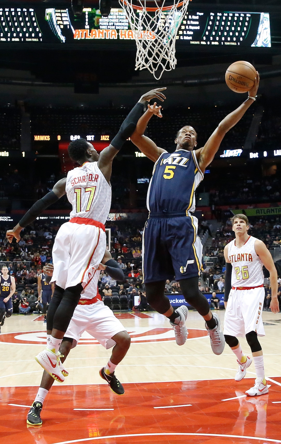 Utah Jazz guard Rodney Hood (5) goes hip for a shot against Atlanta Hawks guard Dennis Schroder (17) in the first half of an NBA basketball game, Sunday, Nov. 15, 2015, in Atlanta. (AP Photo/John Bazemore) 
