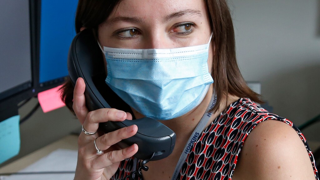 (Rick Bowmer | AP) Health investigator Mackenzie Bray sits in her office at the Salt Lake County Health Department in Salt Lake City, Tuesday, May 19, 202. Bray normally works to track contacts for people with sexually transmitted diseases, but she was re-assigned during the coronavirus pandemic. She is now one of 130 people at this county health department assigned to track down COVID-19 cases in Utah's urban center around Salt Lake City. The investigators, many of them nurses, each juggle 30 to 40 cases that can include a total of several hundred people.