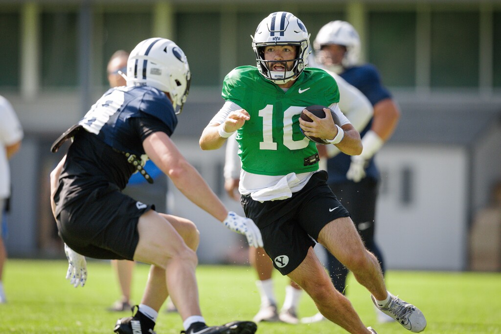 (Jaren Wilkey | BYU) Cougars quarterback Treyson Bourguet runs with the ball during fall camp in Provo, Aug. 2, 2025.
