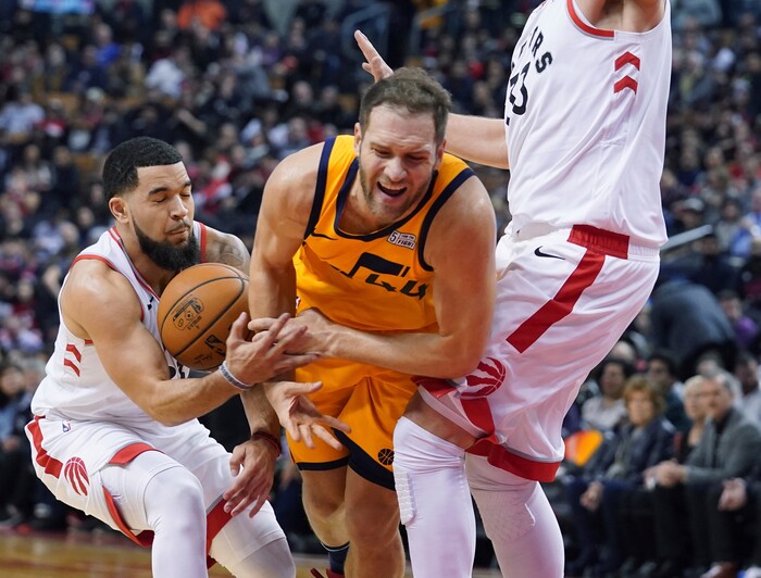 Utah Jazz's Bojan Bogdanovic (44) is fouled by Toronto Raptors' Fred VanVleet (23) during first half NBA basketball action in Toronto, Sunday, Dec. 1, 2019.  (Hans Deryk/The Canadian Press via AP)