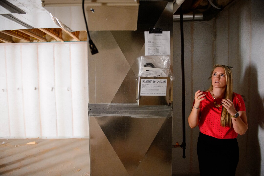 (Trent Nelson  |  The Salt Lake Tribune) Megan Miller shows an energy-efficient home under construction in the Granite Legacy community in South Salt Lake on Tuesday, July 16, 2019. Garbett Homes is behind the project.
