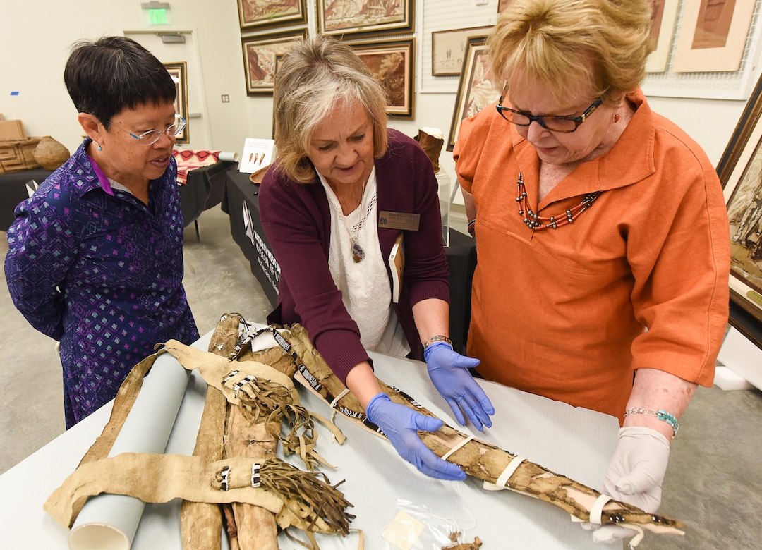 (Francisco Kjolseth  |  The Salt Lake Tribune)  University of Utah Geology and Geophysics Professor Marjorie Chan, Glenna Nielsen-Grimm, an anthropologist with collections and research at the Natural History Museum of Utah and anthropologist Catherine Sweeney Fowler from the University of Nevada, Reno, from left, inspect Ute tribe bow and quiver that was collected by John Wesley Powell, well known in Utah for his famed Colorado River expeditions in1869 and during 1871-1872. The artifacts will be displayed during a public event at the museum Saturday, Sept. 22, for one day only due to the delicate nature of the items.