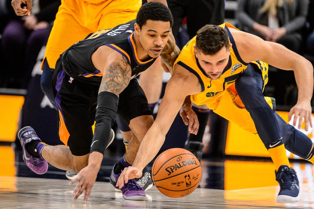 (Trent Nelson | The Salt Lake Tribune)  Phoenix Suns guard Tyler Ulis (8) and Utah Jazz guard Raul Neto (25) dive for the ball as the Utah Jazz host the Phoenix Suns, NBA basketball in Salt Lake City, Wednesday Feb. 14, 2018.