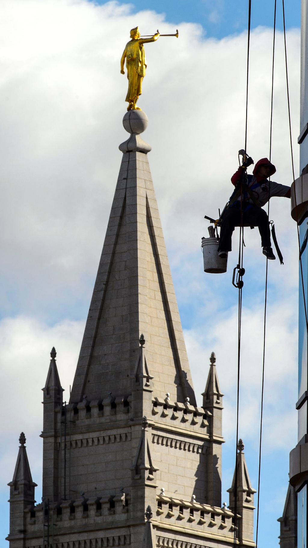 (Steve Griffin  |  The Salt Lake Tribune) A window washer hangs at a building near the LDS Church's Salt Lake Temple last week.