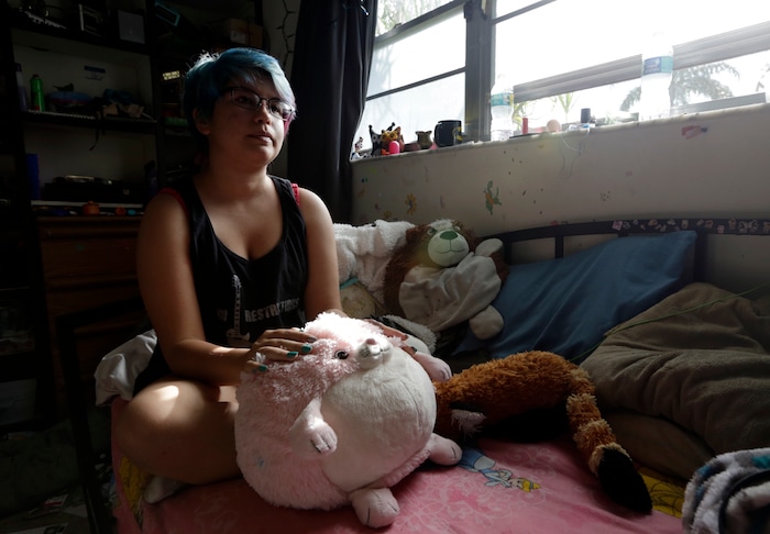 (Lynne Sladky | The Associated Press) In this Monday, March 13, 2017 photo, Theo Ramos, 15, holds his stuffed toy named Strawberry as he sits in his bedroom in Homestead, Fla. Ramos is embracing his gender fluidity, saying, “I present myself differently on different days, depending on what it is I’m doing or who I’m seeing, but my emotions about my gender identity pretty much stay the same.”