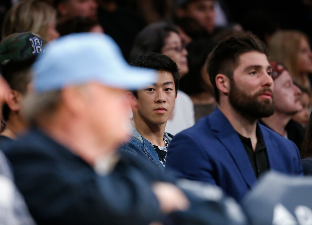 (Ringo H.W. Chiu | AP) Figure skater Nathan Chen attends in an NBA basketball game between Los Angeles Lakers and Miami Heat Friday, March 16, 2018, in Los Angeles. Chen is an avid hoops fan and uses a basketball to help him warm up for skating competitions.