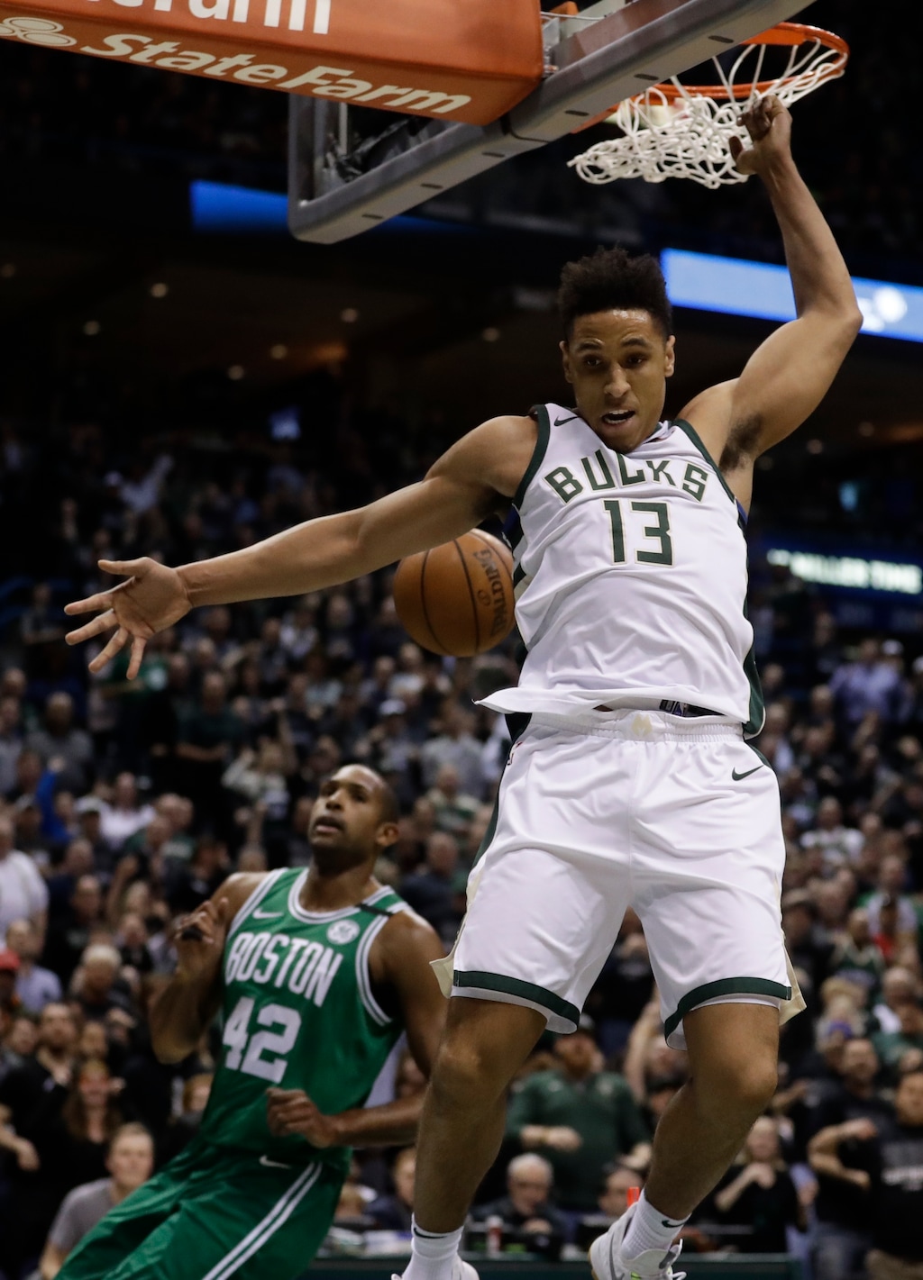 Milwaukee Bucks' Malcolm Brogdon dunks over Boston Celtics' Al Horford during the first half of Game 3 of an NBA basketball first-round playoff series Friday, April 20, 2018, in Milwaukee. (AP Photo/Morry Gash)
