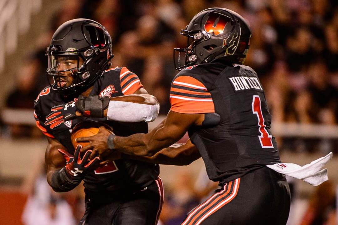 (Trent Nelson | The Salt Lake Tribune)  Utah Utes running back Zack Moss (2) takes the handoff from Utah Utes quarterback Tyler Huntley (1) as the University of Utah hosts Washington at Rice-Eccles Stadium in Salt Lake City, Saturday Sept. 15, 2018.