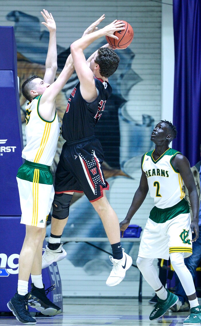 (Leah Hogsten  |  The Salt Lake Tribune) Kearns' Matthew Wickizer (35) tries to stop Weber's Kobe Furqueron (25). Weber defeated Kearns 60-52 in the 6A High School Boys' Basketball Tournament opening game at Weber State University’s Dee Events Center in Ogden, Tuesday, Feb. 27, 2018. 