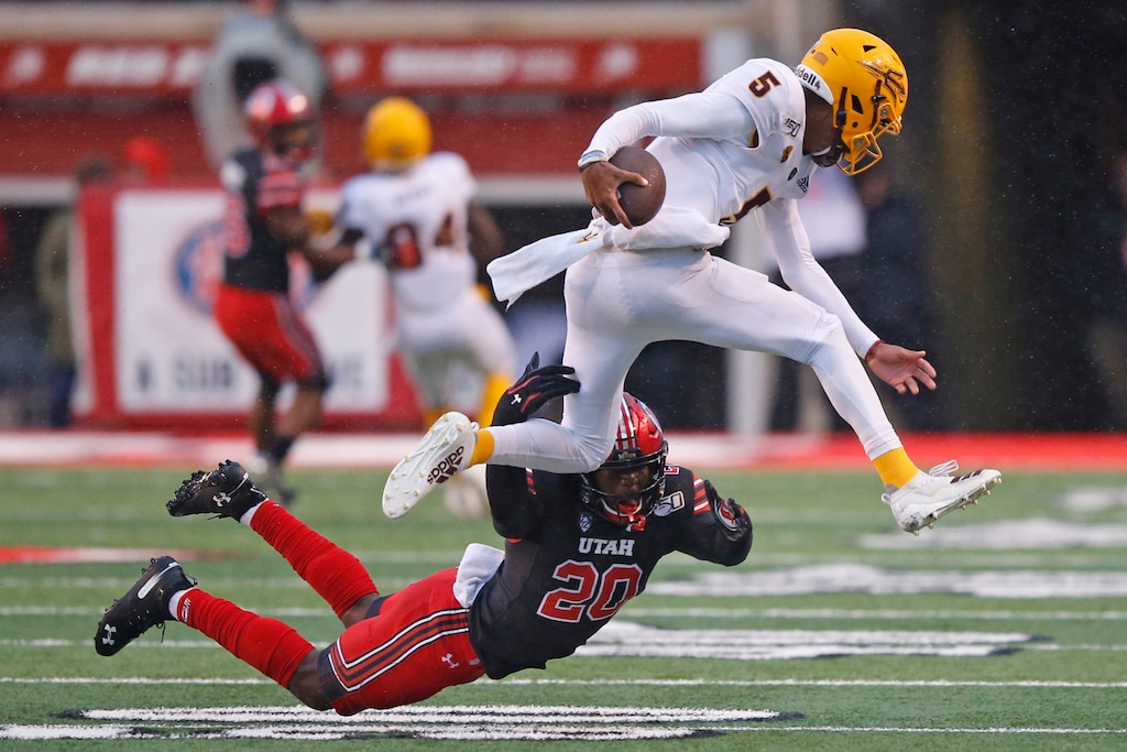 (Rick Bowmer | The Associated Press) Utah linebacker Devin Lloyd (20) tackles Arizona State quarterback Jayden Daniels (5) during the first half of an NCAA college football game Saturday, Oct. 19, 2019, in Salt Lake City.