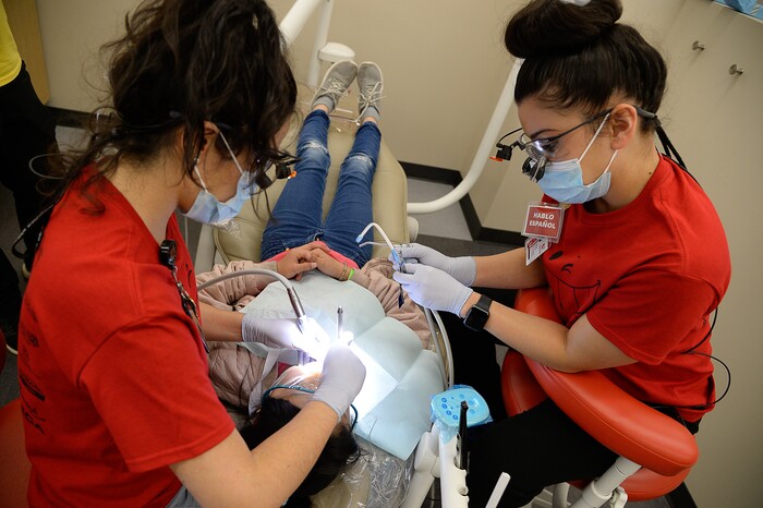(Francisco Kjolseth  |  The Salt Lake Tribune) Diana Arreola, left, and Llely Duarte, both 4th year dental students at the University of Utah, perform a dental filling on a young patient as part of the American Dental AssociationÕs ÒGive Kids a SmileÓ program on Saturday, Feb. 29, 2020. The effort launched in 2003 and gives no-cost care to thousands of kids nationwide.