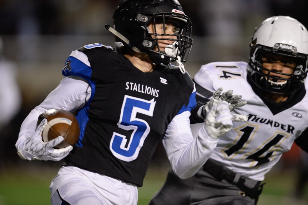 Francisco Kjolseth | The Salt Lake Tribune
McCoy Didericksen of Stansbury, left, looks to gain yards against Desert Hills last season.