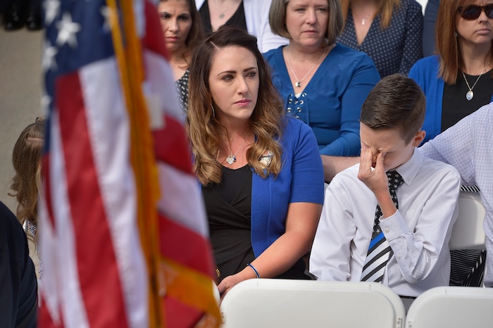 (Scott Sommerdorf | The Salt Lake Tribune)
Draper police Sgt. Derek Johnson's widow Shante Johnson sat with stepson Cayden Stone as they listened to Garon Brett sing "Why" at the Utah Law Enforcement Memorial, Thursday, May 3, 2018.
No Utah law enforcement officer died in the line of duty last year.