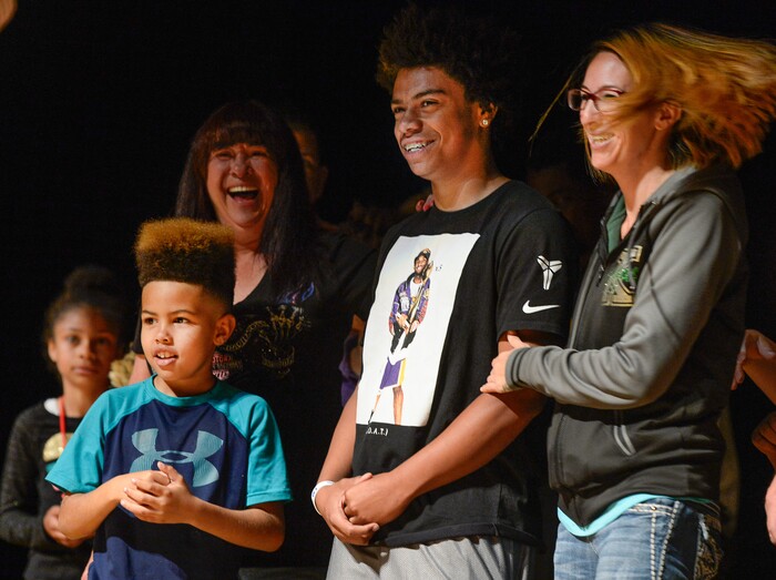 (Francisco Kjolseth  |  The Salt Lake Tribune)  Kearns High sophomore Keeven Wilson, 16, is announced as the Granite School District's Absolutely Incredible Kid award winner alongside his brother Kamani, 9, and foster mother Jessica Wilson during the school farewell assembly on Tuesday, May 22, 2018. Wilson who had a particularly difficult home life, to the point that he and his siblings were taken away from his parents along with near universal F's during his junior high days, turned his life around.  With the help of a new foster family, teachers and his football coach, he is now an honor roll student and thinking of studying psychology in college.
