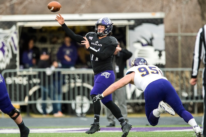 (Chris Detrick  |  The Salt Lake Tribune)  Weber State Wildcats quarterback Stefan Cantwell (11) throws past Western Illinois Leathernecks defensive lineman Mick Nelson (95) during the game at Stewart Stadium Saturday, November 25, 2017.  
