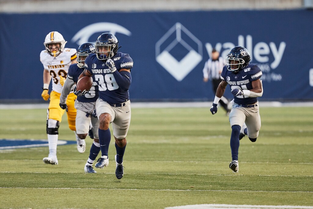 (Photo courtesy of Tyson Bybee, USU Athletics) | Utah State linebacker Eric Munoz (38) runs back one of his two interceptions against Wyoming on Nov. 16, 2019. Munoz, a walk-on making his first start and playing defense in just his second game this season, led USU with 13 tackles and two interceptions.