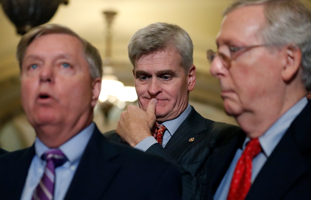 Sen. Bill Cassidy, R-La., center, listens as Sen. Lindsey Graham, R-S.C., left, speaks, accompanied by Senate Majority Leader Mitch McConnell of Ky., on Capitol Hill, Tuesday, Sept. 19, 2017 in Washington. (AP Photo/Alex Brandon)