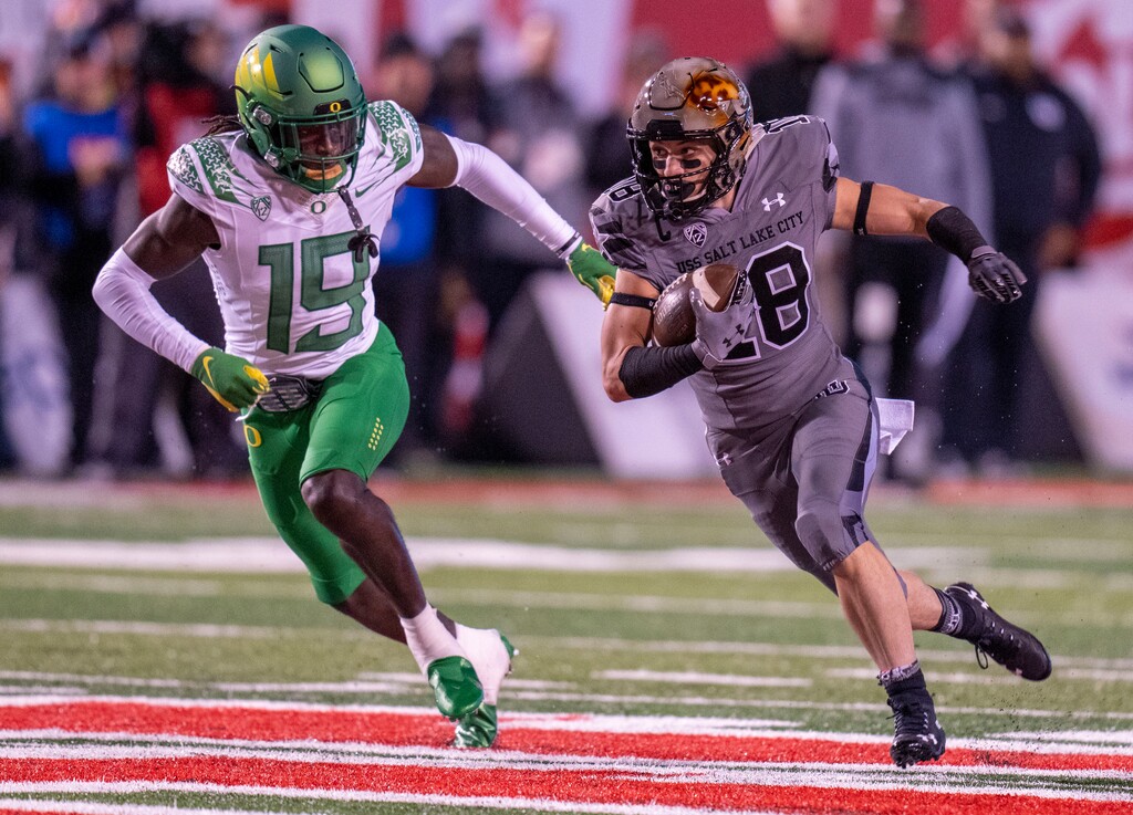 (Rick Egan | The Salt Lake Tribune) Oregon Ducks safety Jamal Hill (19) chases Utah Utes wide receiver Britain Covey (18), in PAC-12 action between the Utah Utes and the Oregon Ducks. At Rice-Eccles Stadium in Salt Lake City, on Saturday, Nov. 20, 2021.