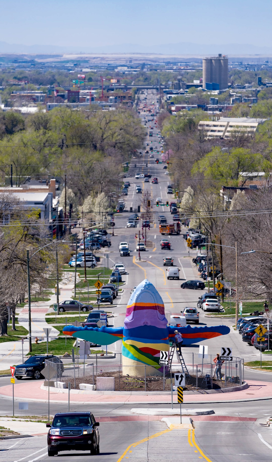 (Francisco Kjolseth | The Salt Lake Tribune) The large breaching humpback whale sculpture at the intersection of 900 South 1100 East gets its inaugural paint scheme inspired by the view of the Salt Lake valley on Friday, April 8, 2022. A new artist is expected to change the paint design every few years. 