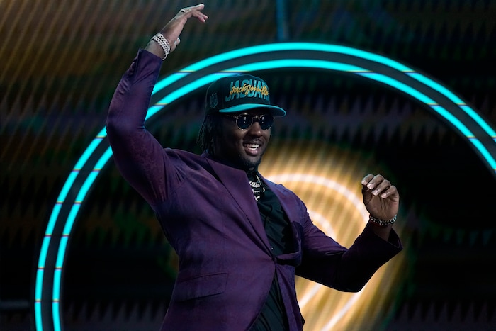 Utah linebacker Devin Lloyd walks on the stage after being chosen by the Jacksonville Jaguars with the 27th pick of the NFL football draft Thursday, April 28, 2022, in Las Vegas. (AP Photo/John Locher)