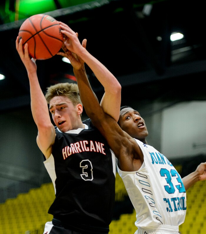 (Steve Griffin | The Salt Lake Tribune) Hurricane's Jackson Last (3) grabs a rebound over Juan Diego's Kemari Bailey (33) during 4A basketball playoff game at the Utah Valley UniversityÕs UCCU Center in Provo Thursday March 1, 2018.