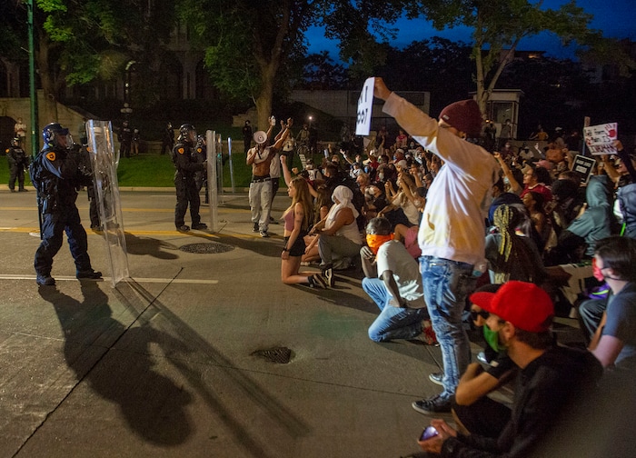 (Rick Egan  |  The Salt Lake Tribune) Marchers kneel down  as the police box in the crowd on South Temple after curfew on Monday, June 1, 2020.