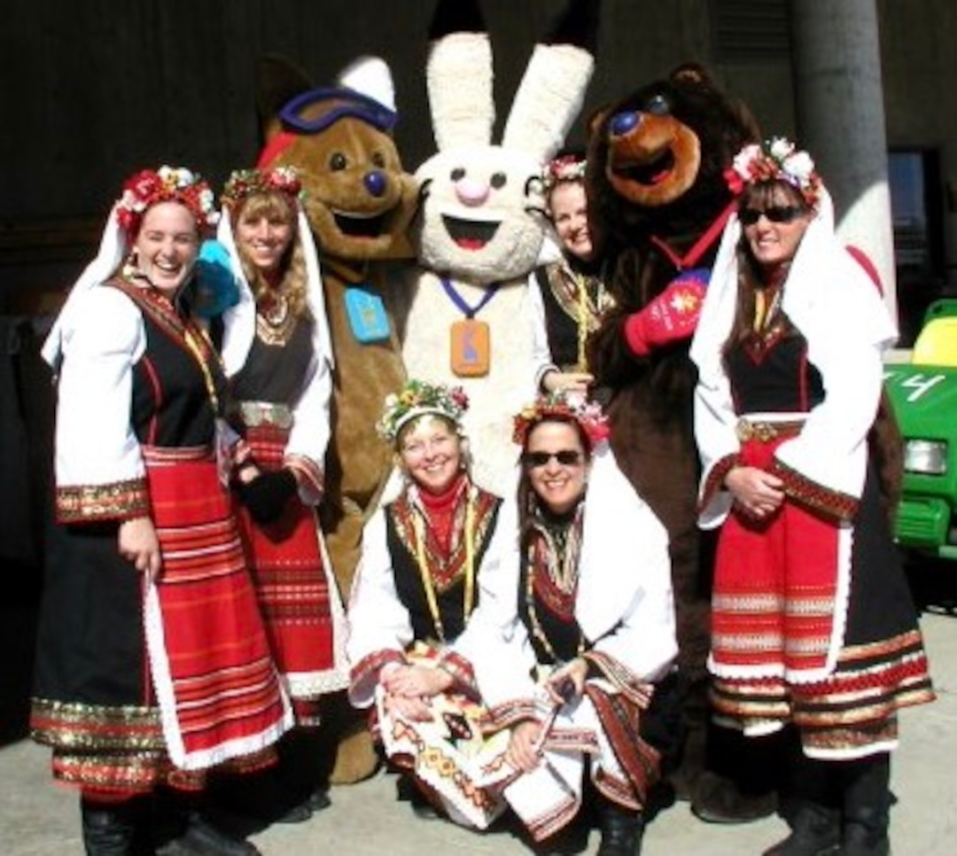 (Photo courtesy of Kathie Allen) The Darena Women's Balkan Choir poses for a picture at the 2002 Olympics in Salt Lake City. Kathie Allen (left) kneels at the front of the group.