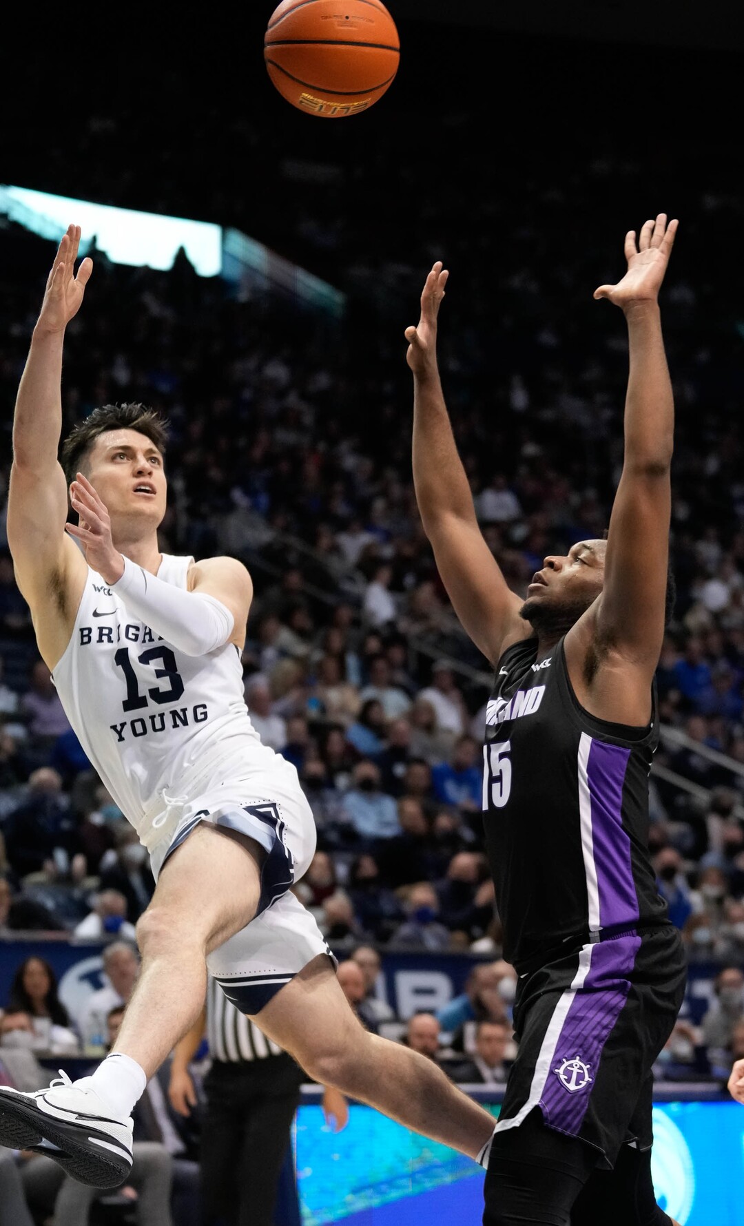 (Francisco Kjolseth | The Salt Lake Tribune) Brigham Young Cougars guard Alex Barcello (13) sails in a shot attempt over Portland Pilots guard Chika Nduka (15) in WCC basketball action between the Brigham Young Cougars and the Portland Pilots, at the Marriott Center, on Saturday, January 22, 2022.